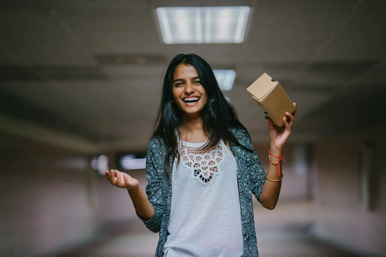 Woman holding a brown cardboard box